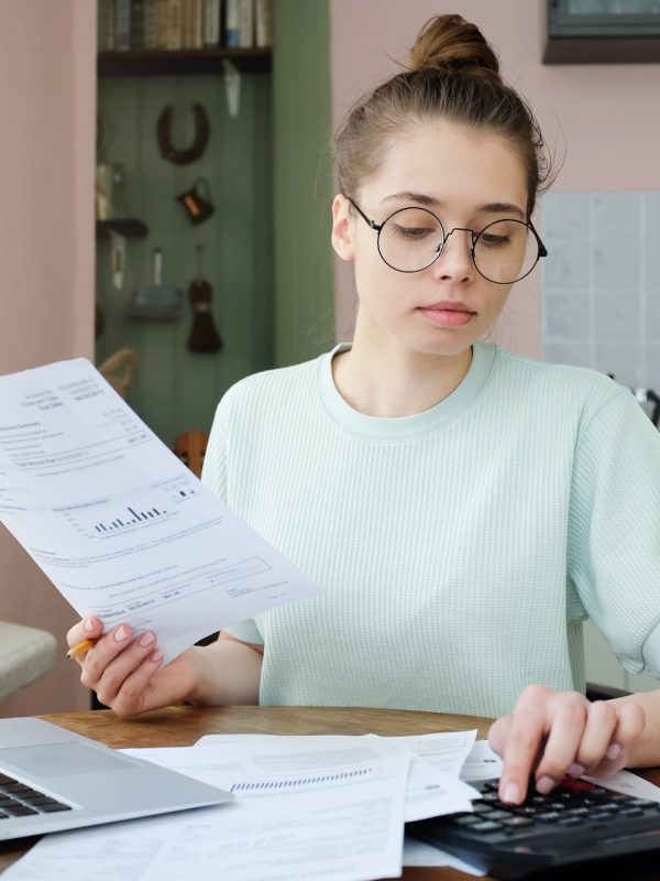 young-beautiful-woman-budgeting-managing-utilities-expenses-writing-financial-plan.jpg